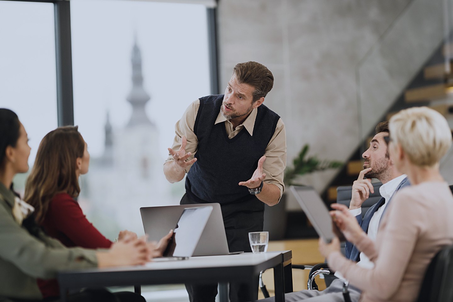 A founder pitching a room of investors around the table